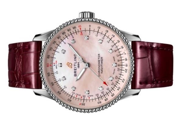 The stainless steel copy watch has wine red strap.
